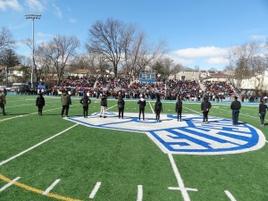 Picture of a participants on the field standing tall during the March of Remembrance on 3/14